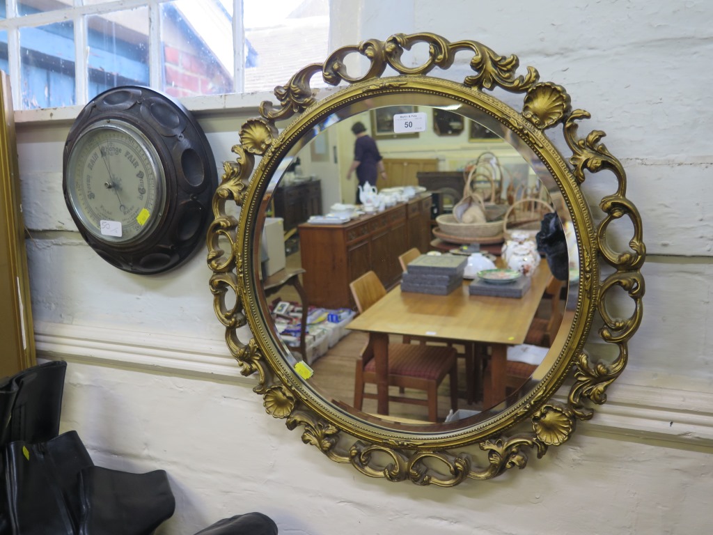 An oak framed Aneroid barometer, and a circular gilt framed wall mirror 55cm diameter (2)