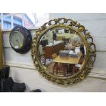 An oak framed Aneroid barometer, and a circular gilt framed wall mirror 55cm diameter (2)