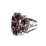 A pink sapphire and diamond ring set in 18 carat white gold