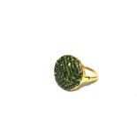 A gold ring set with green garnets