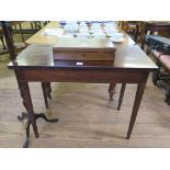 A cross-banded mahogany foldover tea table, boxwood and ebony strung frieze on square section