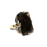 A 9 carat gold ring set with a large smokey quartz stone