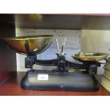 A set of brass and blacked metal kitchen scales