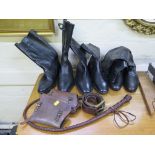 A pair of leather riding boots, various other leather boots, a belt and a whip