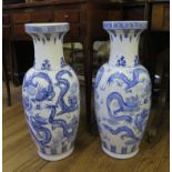 A pair of Chinese underglaze blue baluster vases with relief decorated dragon and ball design 64cm