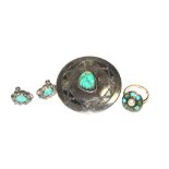 A turquoise and silver ring, a pair of earrings and a brooch