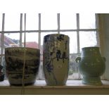 Three Oriental vases, one depicting a landscape 27.5cm high, another of birds in branches 38cm