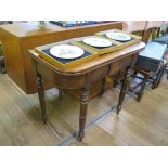 A Victorian mahogany foldover tea table, with tablet frieze on ring turned legs 91cm wide