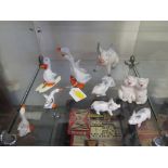 Four Beswick novelty geese figures, including one skiing together with five Beswick novelty pig