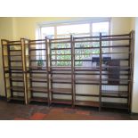 A set of stained wood stacking bookcases with canework sides, each of the ten sections with three