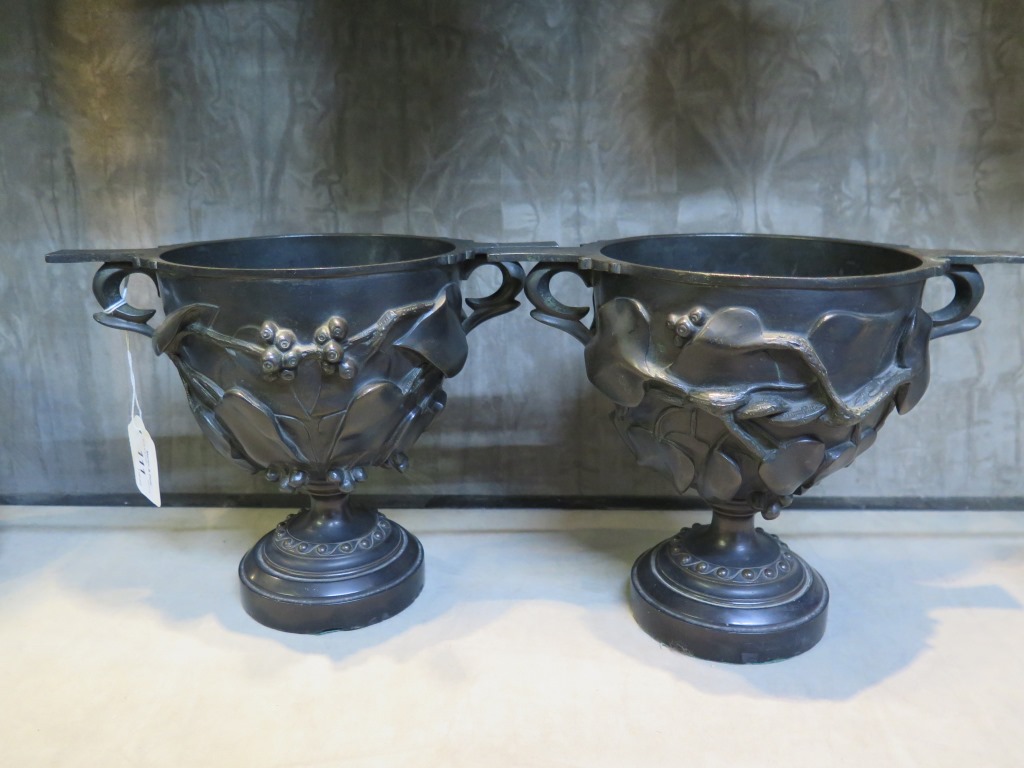 A pair of 19th century bronze urns, with all over ivy design, 18.5cm high