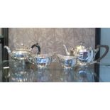 A three piece silver plated tea set and a plated tea pot