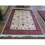 *A Keshan style rug, the ivory field with all over foliate scroll design within a multiple border