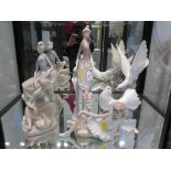 A Lladro figure of a dove 27.5cm high, another of a dove, a Lladro figure of a lady with an