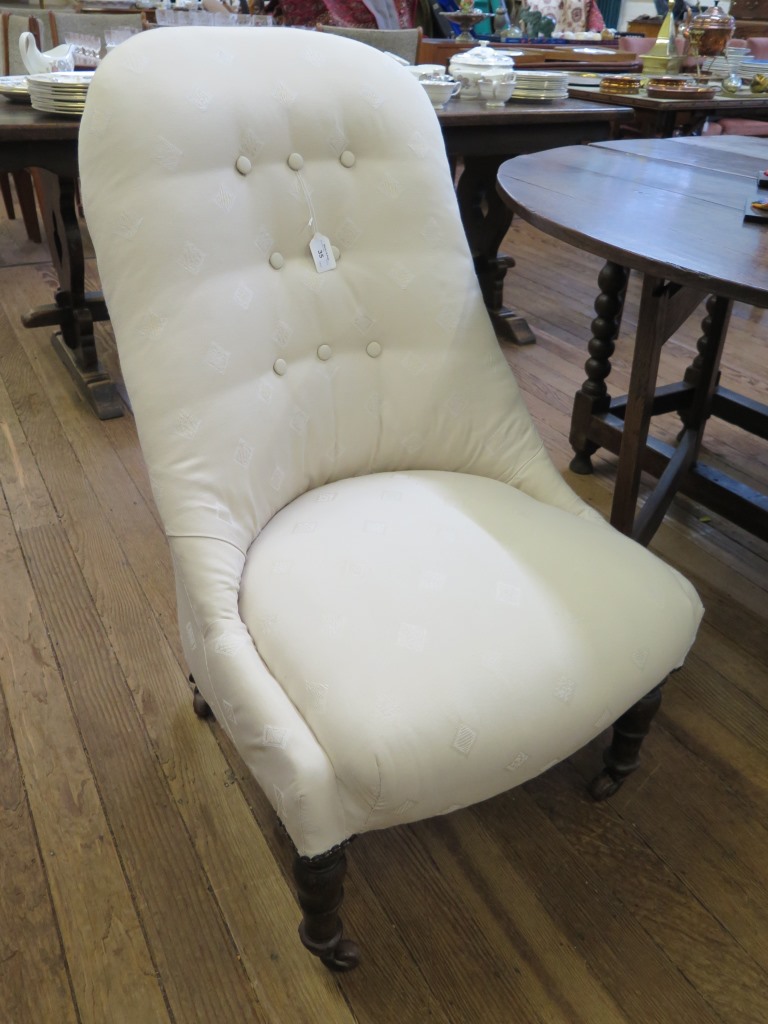 A late Victorian stained beech nursing chair, the button back and padded seat on turned tapering