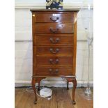 An Edwardian crossbanded mahogany chest of six narrow drawers on cabriole legs with pad feet 50.