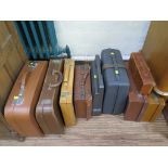 Various leather suitcases and two typewriters