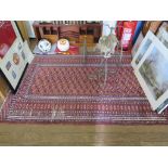 A Bokhara rug, the three columns of seventeen guls on a red field within a multiple border, 188cm