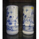 A pair of Japanese blue and white bamboo shape vases, with floral decoration 24cm high, unmarked (