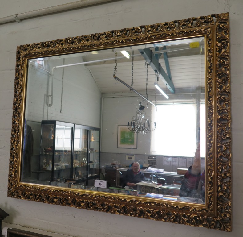 A gilt framed wall mirror, the bevelled rectangular plate within an acanthus scroll frame 57cm x