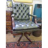 *A leather button back office armchair, adjustable and on castors