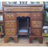 *A George III mahogany kneehole desk, the crossbanded top over a slide and long drawer above a