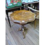 An Italian inlaid walnut tripod table, with shaped circular top on a baluster stem and moulded