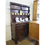 A dark oak Ercol dresser and rack, with two short drawers and two cupboard doors, 123cm