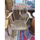 An ash windsor style armchair, with pierced splat, moulded seat and turned legs joined by a
