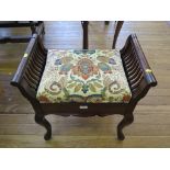 An Edwardian mahogany piano stool, the scroll arms above a hinged seat and cabriole legs