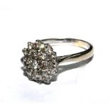 A diamond cluster ring set in 18 carat white gold