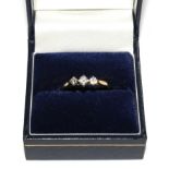 A three stone diamond ring set in 18 carat yellow gold