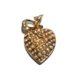 A 15 carat gold heart pendant, set with seed pearls