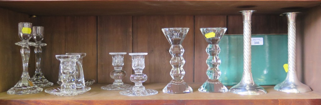 A collection of five pairs of various cut glass candlesticks