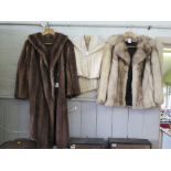 A full length fur coat, a short coat and other furs