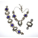 A silver colour bracelet, set with three cameos and deep blue stones, a matching necklace and a