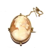 A cameo brooch depicting head and shoulder of a lady