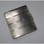 A silver and gold colour metal cigarette case