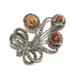 A white metal brooch set with marcasites and moss agates