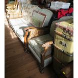 A 1920s three piece bergere suite comprising three seat settee and two armchairs, with cane sides,