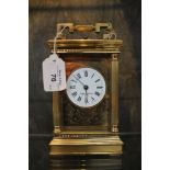 *A brass carriage clock retailed by Mappin & Webb, the circular enamel dial within fluted columns on