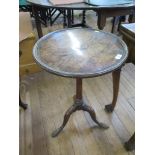 A George III oak circular snaptop tripod table, with birdcage hinge on a turned stem and cabriole