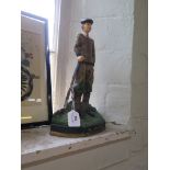 A cast iron painted doorstop modelled as a golfer