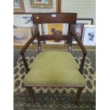 A Regency mahogany carver chair, the tablet top rail and rail above an overstuffed seat on sabre