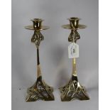 A pair of Art Nouveau style brass candlesticks, 25cm high