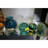 Three Mdina Malta glass paperweights, signed and a small vase