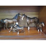 Two Beswick figures of horses, one repaired, 22cm high and three Beswick figures of foals, one