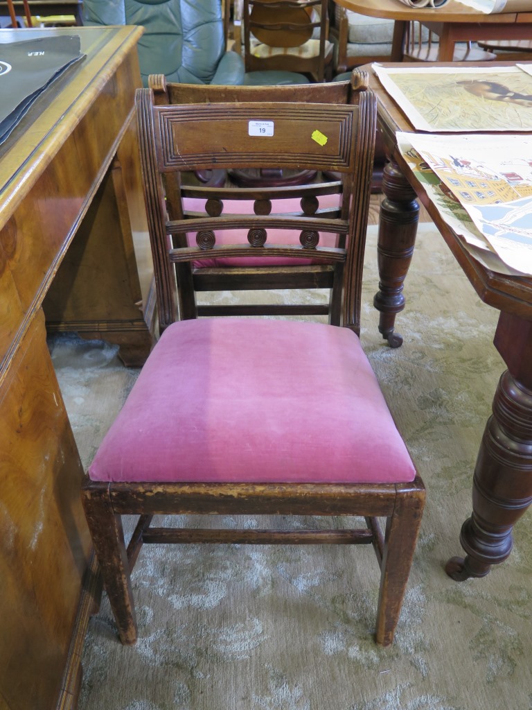 A pair of Regency mahogany dining chairs, the reeded tablet back with roundel mid rails over drop in