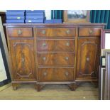 A reproduction mahogany breakfront side cabinet with three drawers over three further drawers