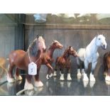 A Beswick figure of a grey horse, another of a horse with hoof raised, two other shire horses and